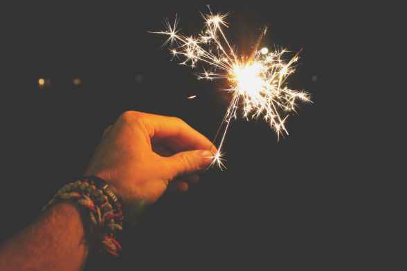 photo of person holding sparkler